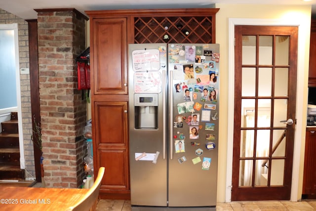 kitchen with brick wall and stainless steel fridge with ice dispenser