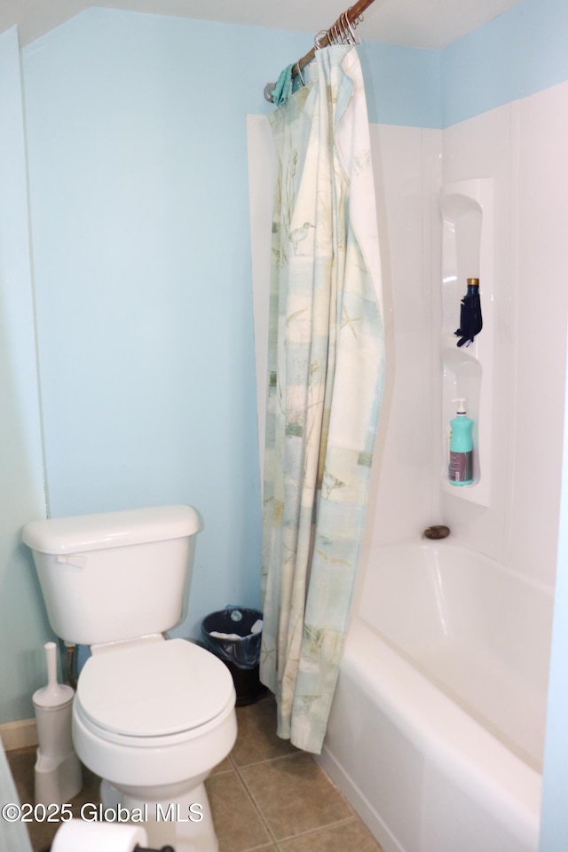 bathroom with shower / tub combo, toilet, and tile patterned floors