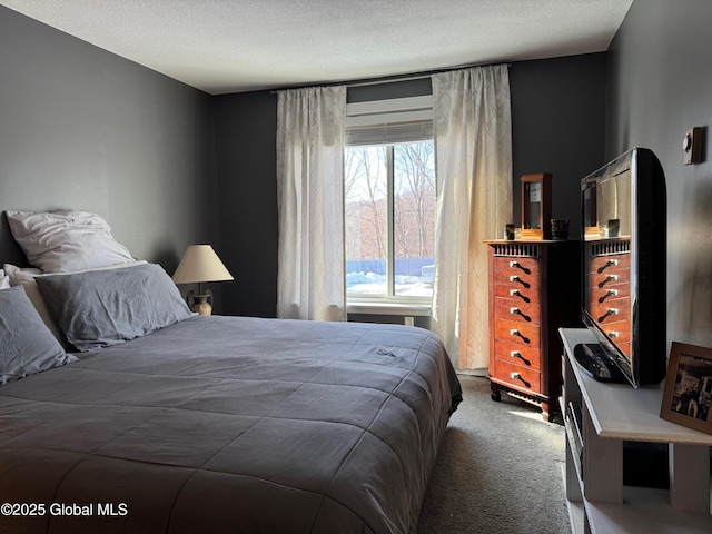 carpeted bedroom featuring a textured ceiling