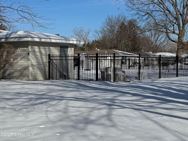 snow covered gate featuring fence