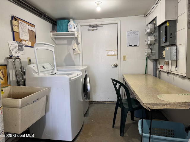 laundry area featuring separate washer and dryer and a sink