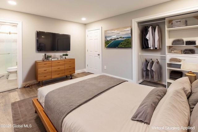 bedroom featuring recessed lighting, ensuite bath, baseboards, and wood finished floors