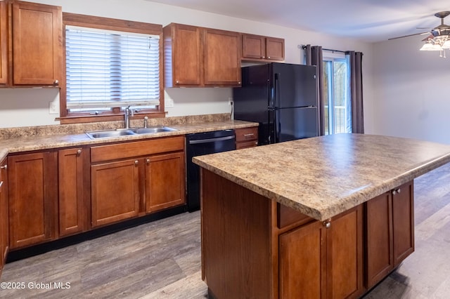 kitchen featuring ceiling fan, black appliances, brown cabinets, and a sink