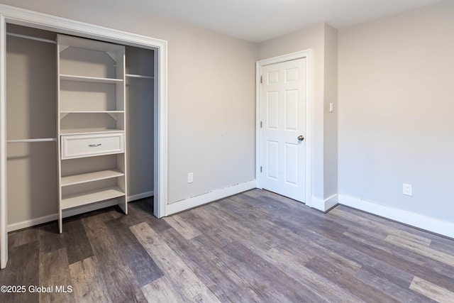 unfurnished bedroom with baseboards and wood finished floors