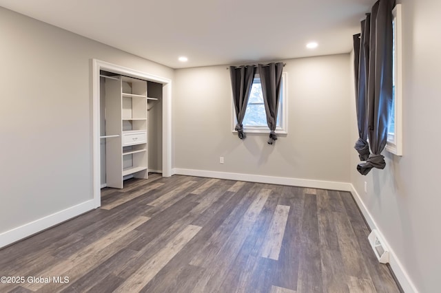 unfurnished bedroom with recessed lighting, baseboards, and dark wood-style flooring