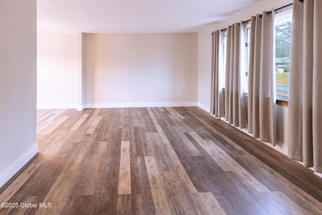 unfurnished room featuring wood finished floors and baseboards