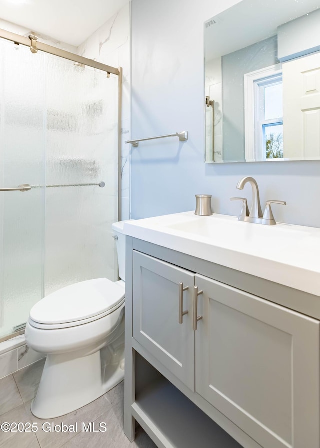 full bathroom with vanity, a shower stall, toilet, and tile patterned floors