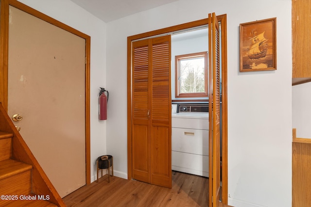 corridor featuring washer / clothes dryer and wood finished floors