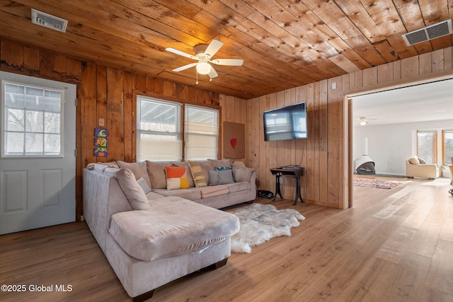 living area with wood ceiling, visible vents, ceiling fan, and light wood-style flooring