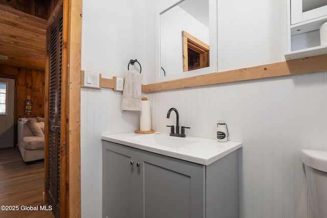 bathroom with wood finished floors and vanity