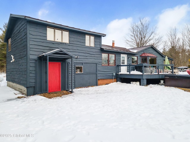 view of front of house with a chimney and a wooden deck