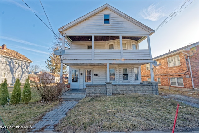 view of front of property with a balcony and covered porch