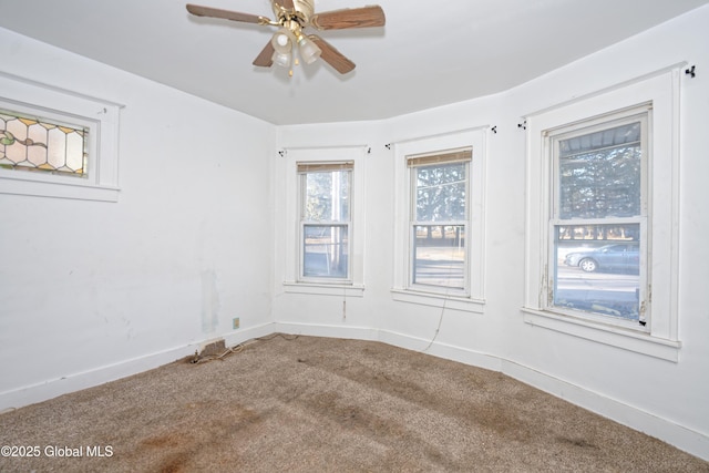 unfurnished room featuring carpet, baseboards, and ceiling fan