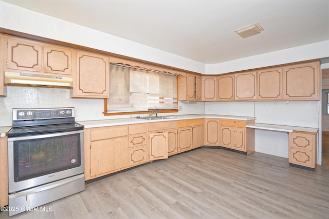 kitchen featuring a sink, light countertops, electric stove, under cabinet range hood, and light wood-type flooring