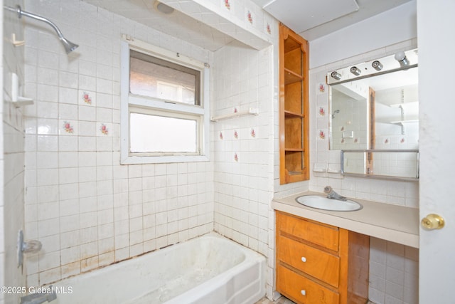 bathroom featuring decorative backsplash, vanity, tile walls, and washtub / shower combination