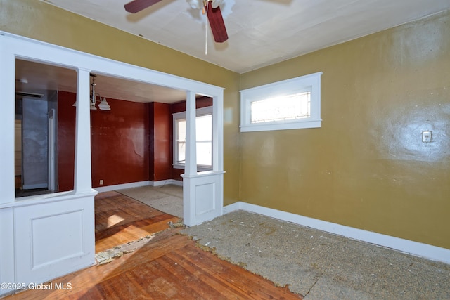 empty room featuring baseboards and ceiling fan