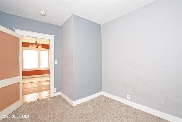 spare room featuring baseboards and carpet floors