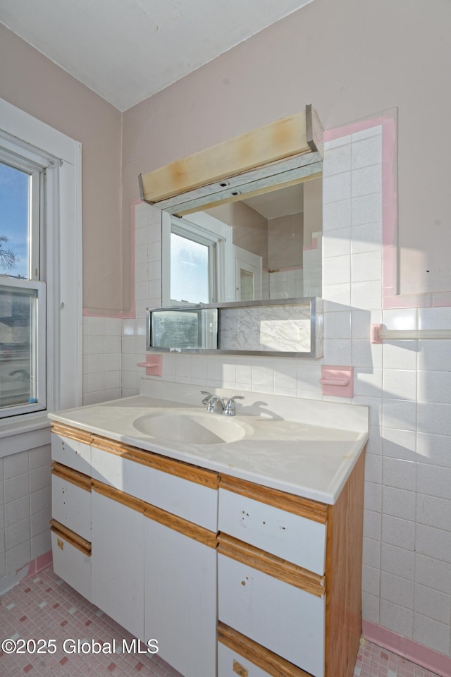 bathroom with tile walls and vanity