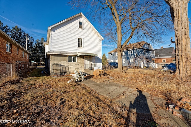 back of property with a patio and fence