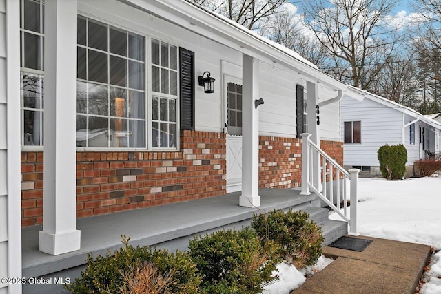 view of exterior entry with brick siding