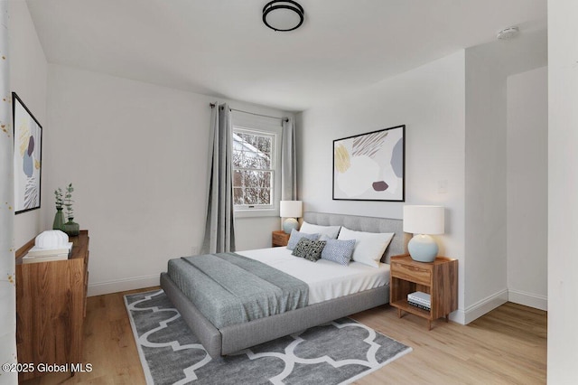 bedroom with wood finished floors and baseboards