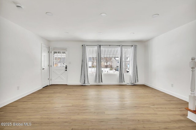 interior space with light wood-type flooring and baseboards