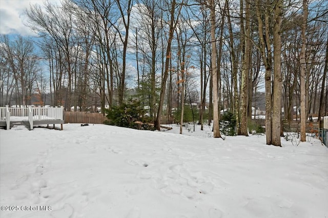 snowy yard with fence