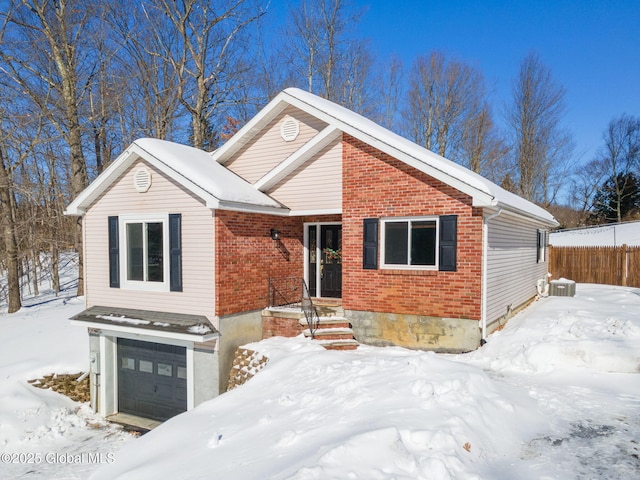 single story home featuring a garage and brick siding