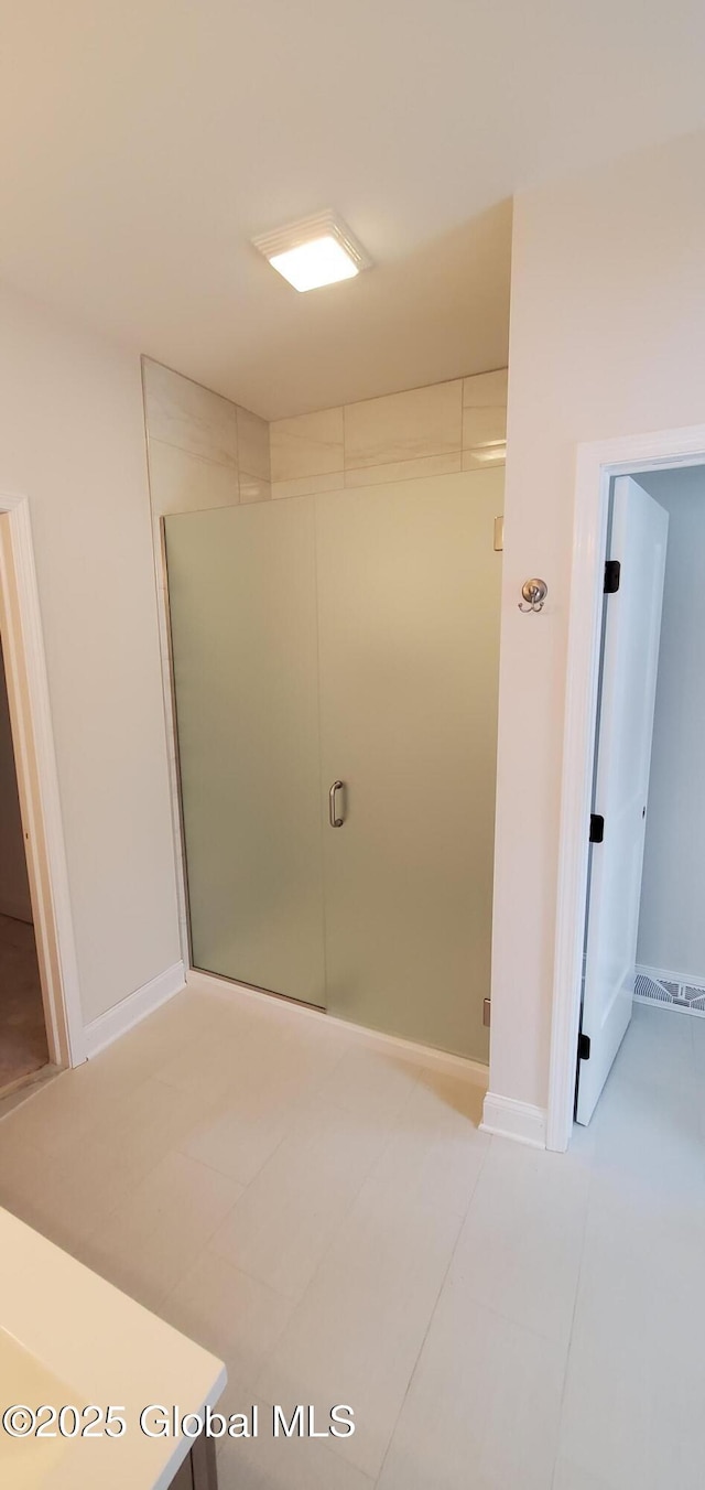 bathroom with tile patterned flooring and baseboards