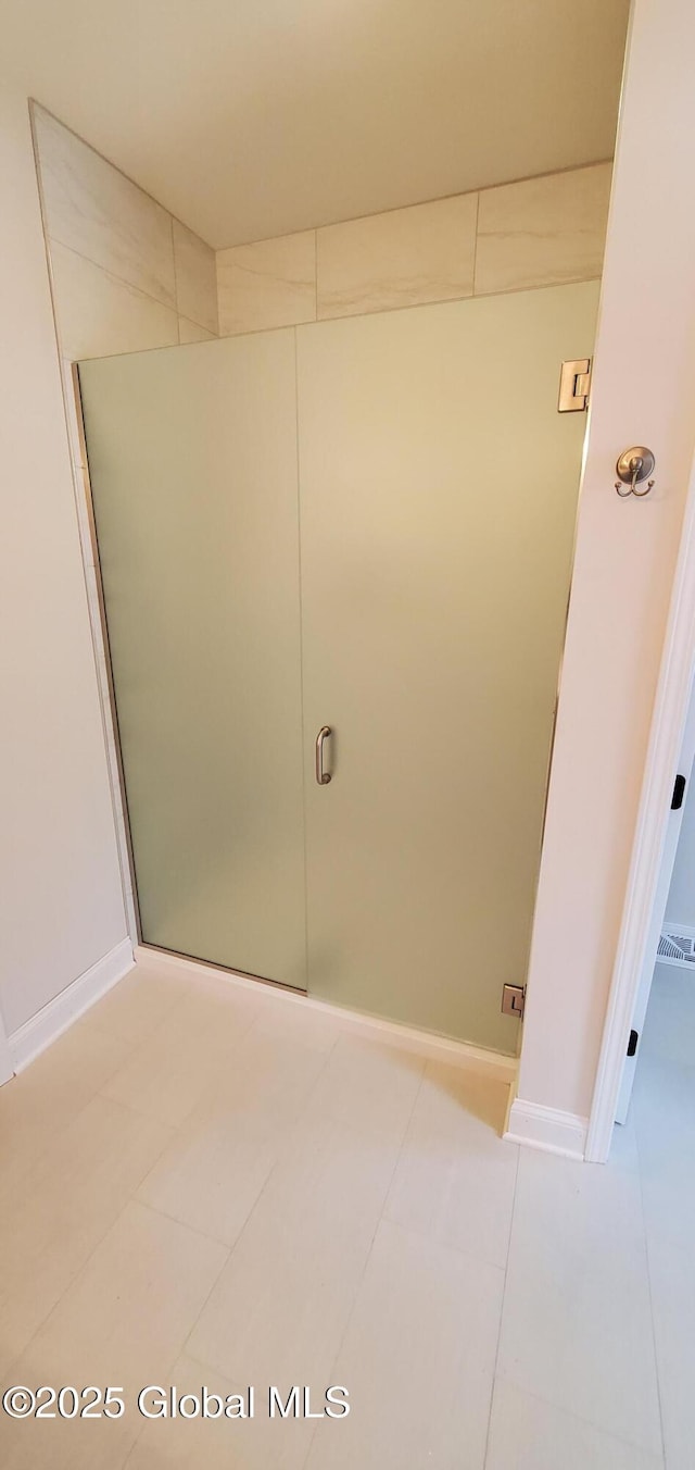 bathroom with tile patterned flooring and baseboards