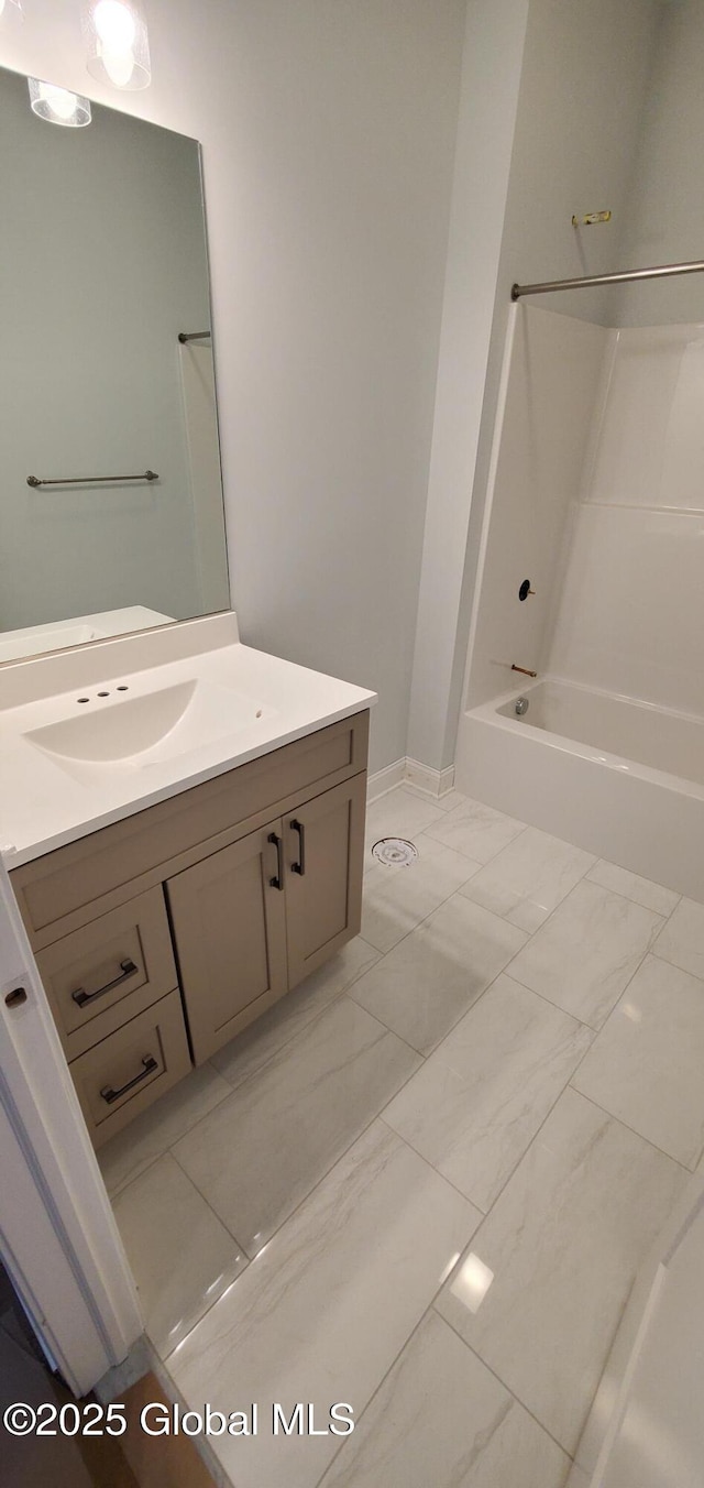 full bathroom with marble finish floor, shower / tub combination, and vanity