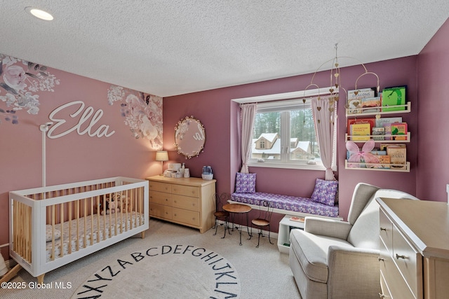 bedroom with a textured ceiling and light colored carpet