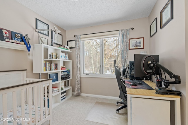 office space featuring light carpet, a textured ceiling, and baseboards