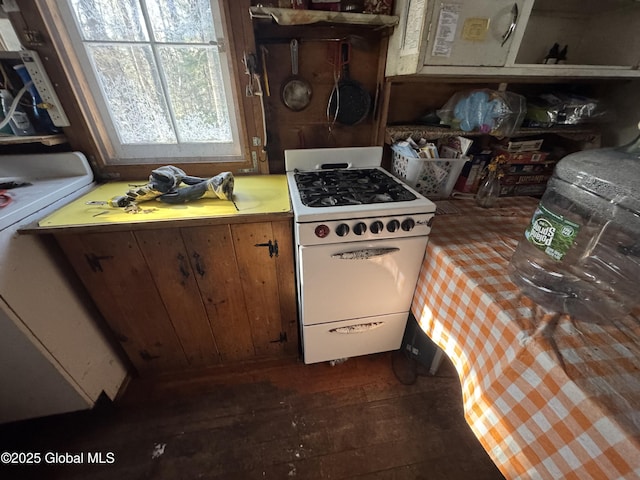 kitchen with stove, white range with gas cooktop, light countertops, and dark wood-style floors