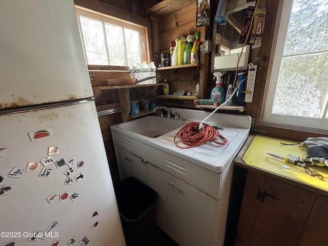 kitchen with a wealth of natural light, a sink, and open shelves