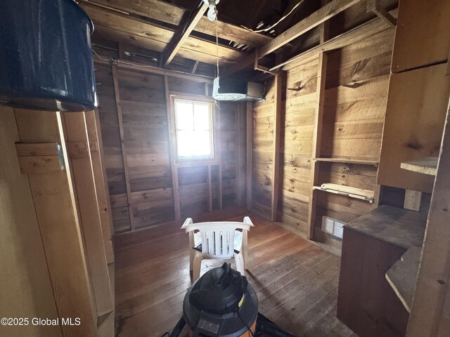 interior space with wooden walls and hardwood / wood-style floors