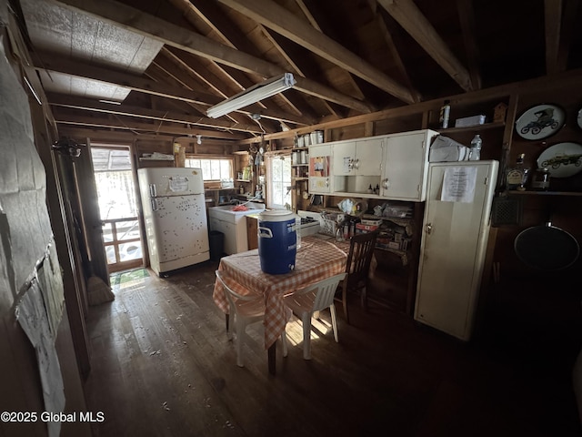 kitchen with dark wood finished floors, washer / clothes dryer, freestanding refrigerator, and open shelves