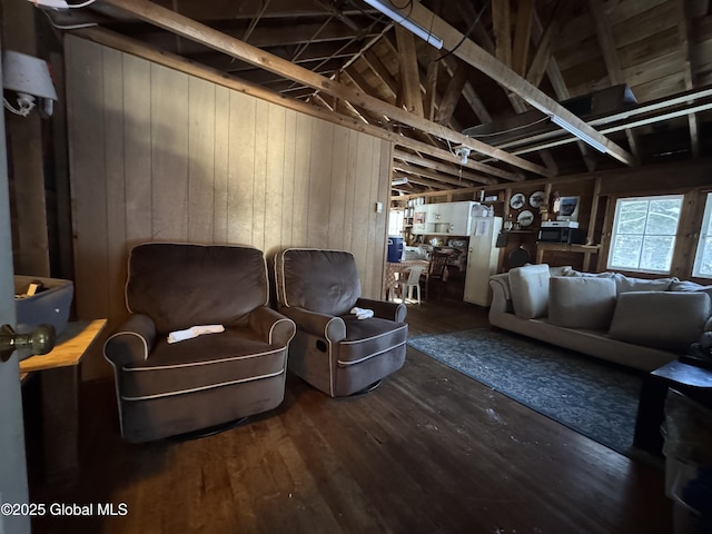 living room with wood finished floors and wood walls