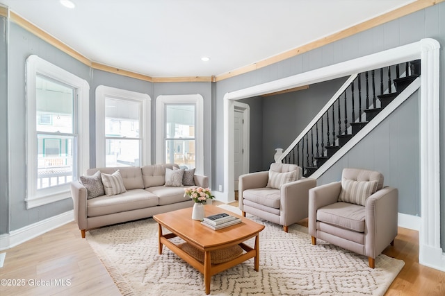 living area with light wood-type flooring, stairs, baseboards, and recessed lighting