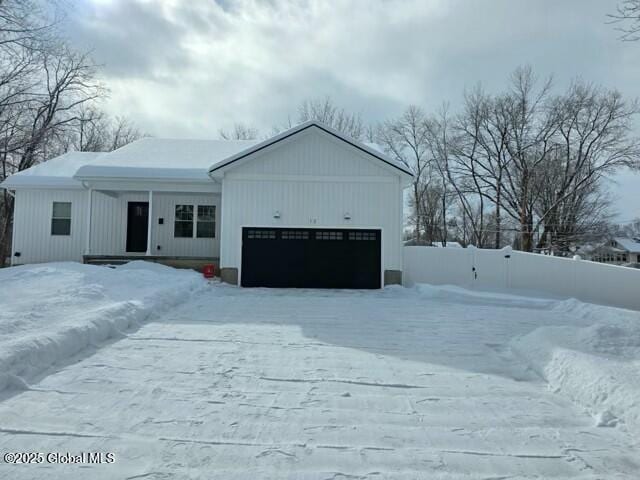 view of front of home featuring a garage and fence