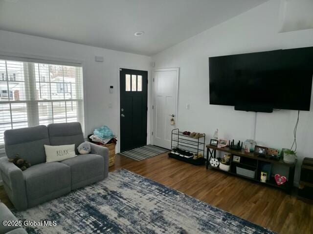 living area with lofted ceiling and wood finished floors