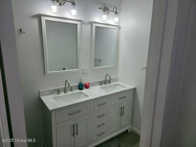 full bath with a sink and double vanity