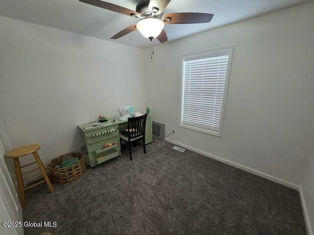 unfurnished office featuring carpet floors, baseboards, and a ceiling fan