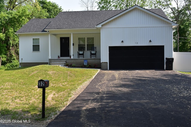 32 Swan St, Kingsbury, NY 12839 - view of front of home with a porch, a garage, roof with shingles, and driveway
