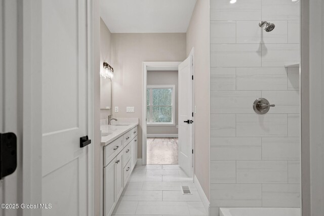 706 Swaggertown Rd, Charlton, NY 12302 - bathroom featuring vanity, tiled shower, and baseboards