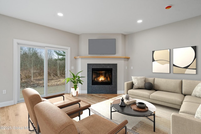 706 Swaggertown Rd, Charlton, NY 12302 - living room featuring light wood-style flooring, a glass covered fireplace, recessed lighting, and baseboards