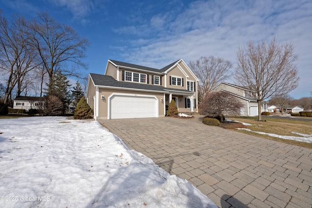 view of front of property featuring decorative driveway and an attached garage