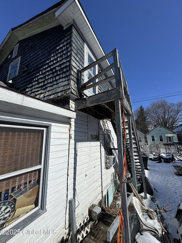 view of snowy exterior with stairs