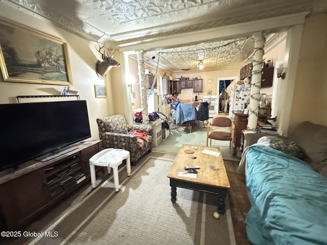 living area with an ornate ceiling and ornamental molding