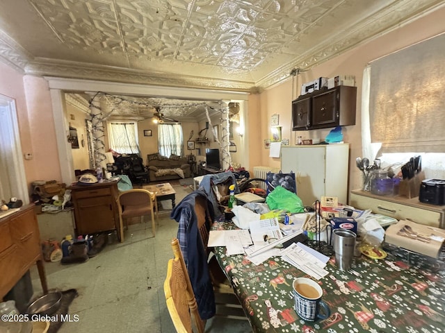 interior space with a ceiling fan, radiator heating unit, an ornate ceiling, and crown molding